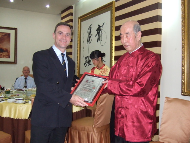 Simon receiving Ru Shi Di Zi certificate